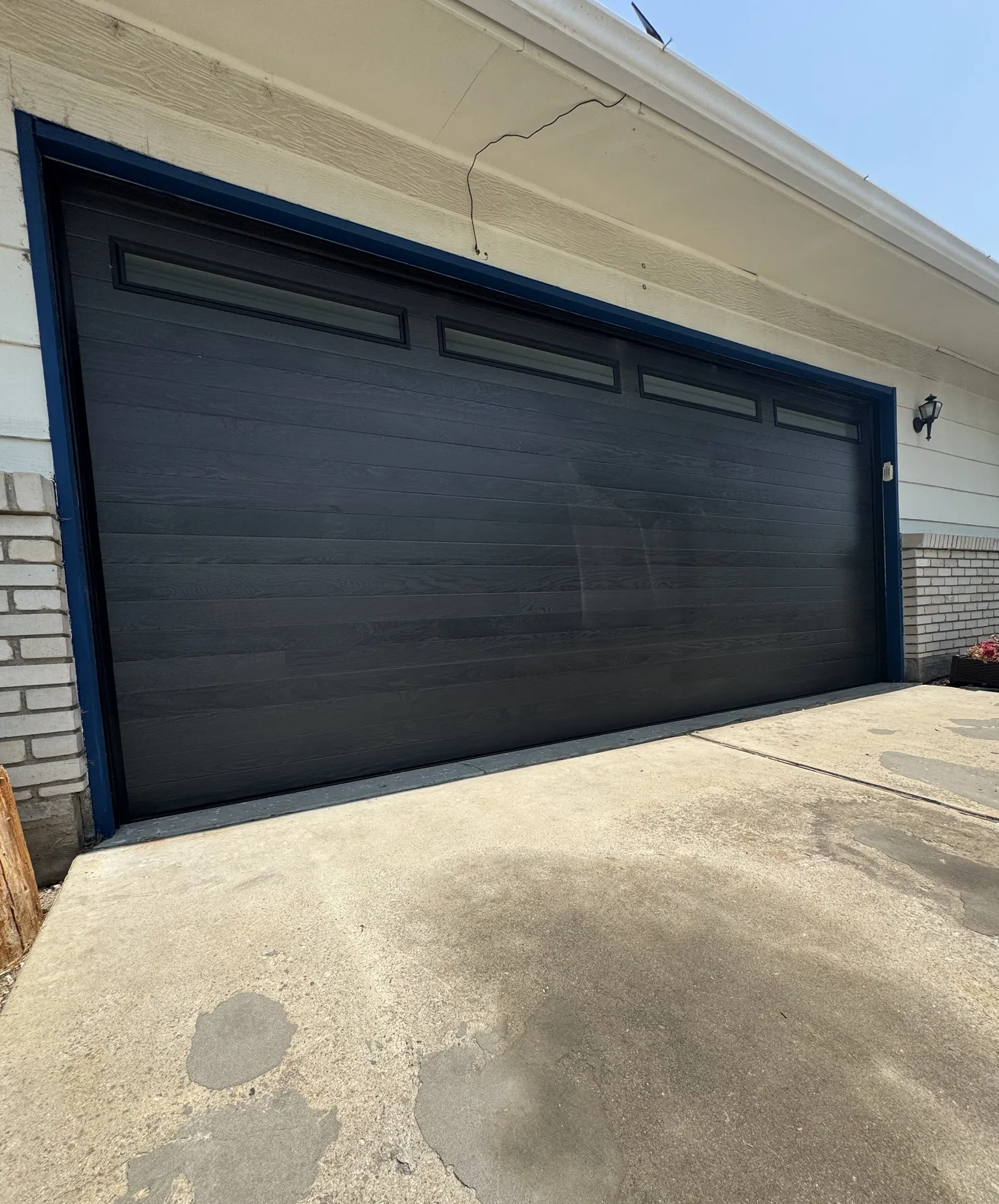 Close exterior view of an Amarr Northwoods garage door in Onyx installed by LIFTX